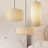 Two ribbed silk drums lit above a seating area