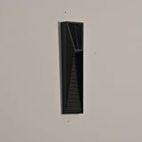 The medium size unlit on a beige wall, the tapered louvered front clear