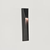 The light lit and seen from the side on a white wall, the louvers catching the glow