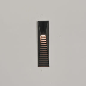 The short size lit on a pale wall, the warm band under the solar cell