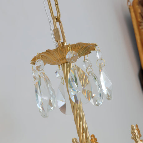Close view of the crystal drops hanging from the gold arm