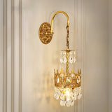 The crown sconce lit on a white paneled wall with molding