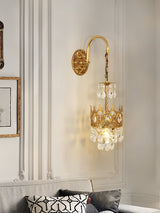 The crown sconce lit on a paneled wall above a sofa with patterned cushions
