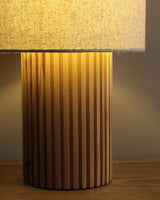 Close view of the fluted wood base lit from the shade above it