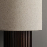 Close view of the woven linen shade above the fluted wood column