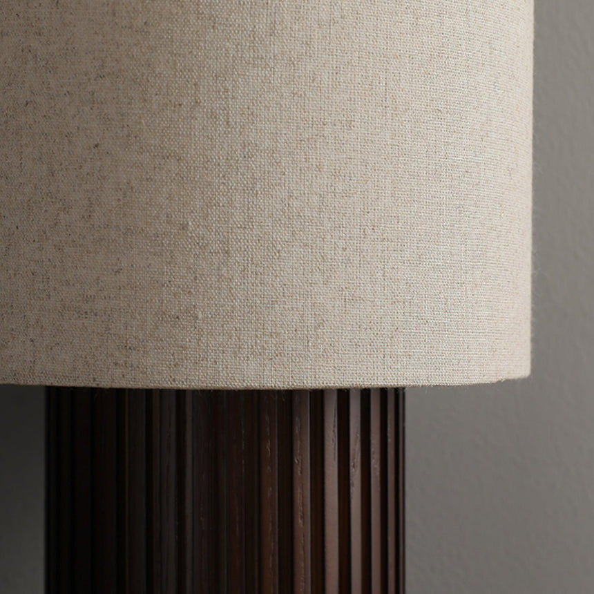 Close view of the woven linen shade above the fluted wood column