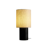 Walnut entryway table lamp lit and seen from the front, plain background