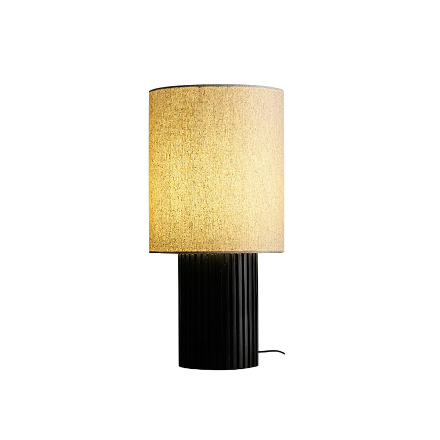 Walnut entryway table lamp lit and seen from the front, plain background