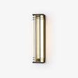 Black box outdoor wall light with gold tone trim and a ribbed acrylic panel, lit warm