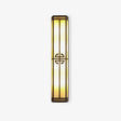 Tall exterior wall sconce, a slim lantern column with glowing panels and a round fretwork medallion