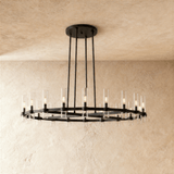 The same wide ring in black, glass candle tubes lit around its full circumference