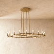 A wide brass ring carrying a row of clear glass candle tubes on four long stems