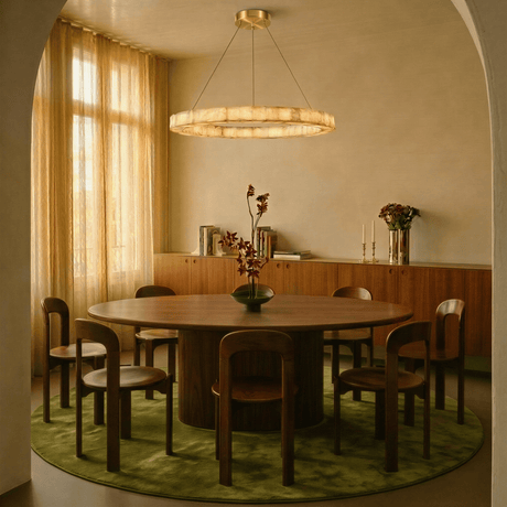 One lit ring above a round dining table standing on a green rug