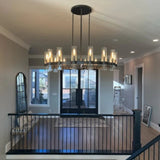 The black ring lit above a stair landing with a railing and a tall window