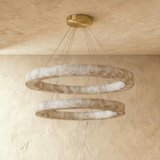 Two rings of pale veined stone seen against a plaster ceiling