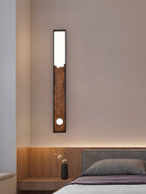 Bar upright on a warm plaster wall beside a bed and a small side table