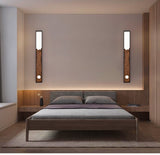 Two bars upright on either side of a bed with a low wood platform
