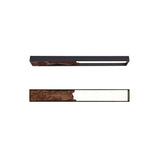 Walnut version of the carved bar shown upright and lying flat, lit warm