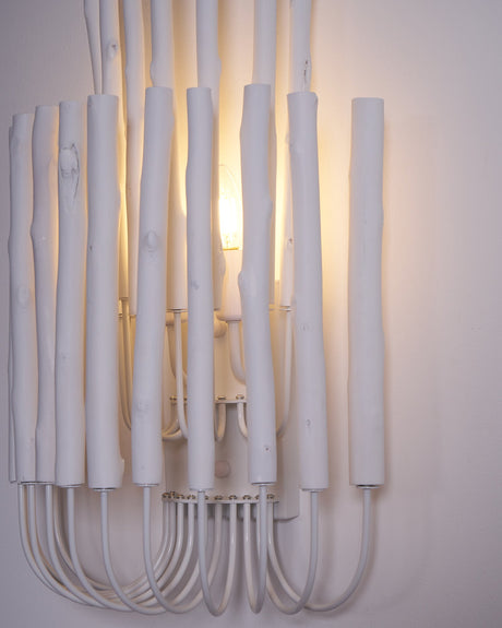 The rod cluster lit and seen from an angle, showing its depth on the wall