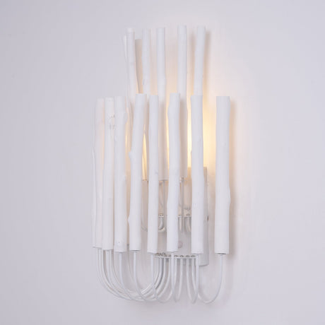 White wood rods of uneven height standing on looped wire, seen straight on
