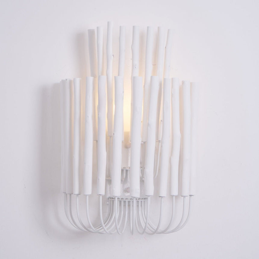 White wood rods lit from within, the light rising between the sticks