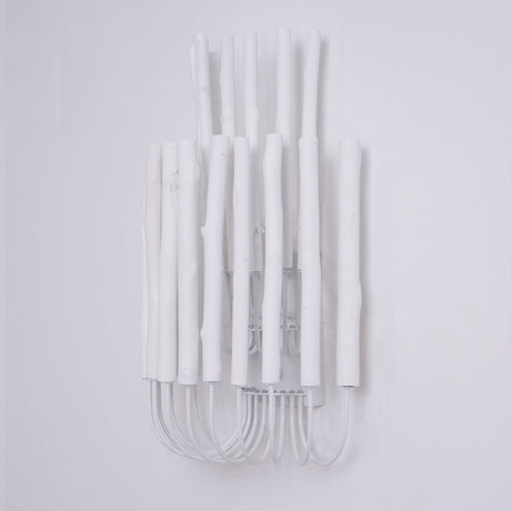 Cluster of white wood rods unlit, the looped frame visible underneath