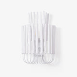 Extra large wall sconce built from white wood rods on a curved wire frame