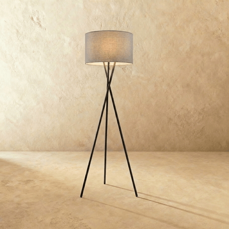 The crossed black tripod carrying a gray fabric drum shade at the top