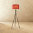 The crossed black tripod with a red fabric drum shade at the top