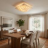 Square silk ceiling light above a dining table with upholstered chairs