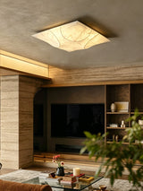 Square silk ceiling light above a living room with a media wall