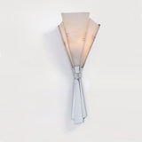 The fan sconce lit, the veining of the alabaster showing through