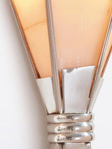 Close view of the lit alabaster blades and the polished metal band