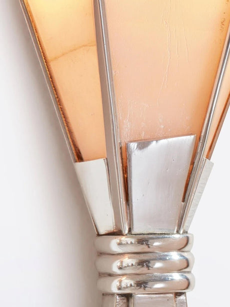 Close view of the lit alabaster blades and the polished metal band