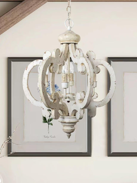 The fitting lit beside framed art above a painted wall panel