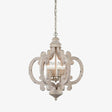 Carved wood chandelier in antique white with six candle lamps inside
