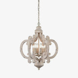 Carved wood chandelier in antique white with six candle lamps inside