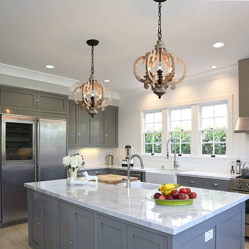 The crown lit above a kitchen island with a marble counter and bowl