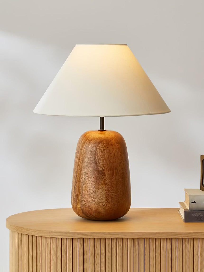 Farmhouse table lamp on a fluted wooden sideboard beside small books