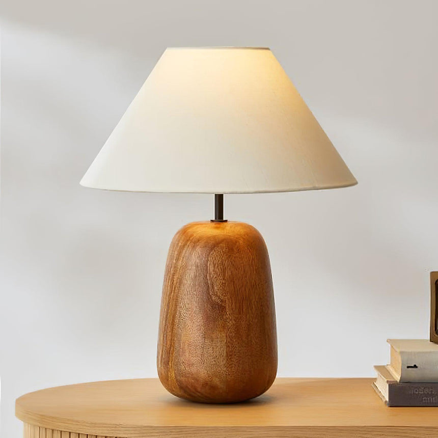 Farmhouse table lamp on a pale round table beside two small books