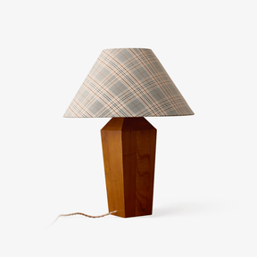 Table lamp with a plaid coolie shade on a square tapered wood post