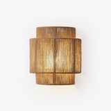 Wall lamp with a two tier shade of handwoven hemp rope, lit warm from inside