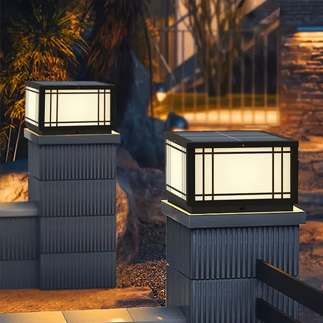 The lantern glowing on a pillar against dark timber cladding