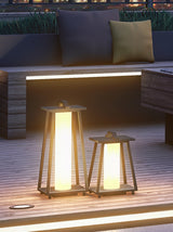 Two lit beside a long bench seat with a pale cushion on it