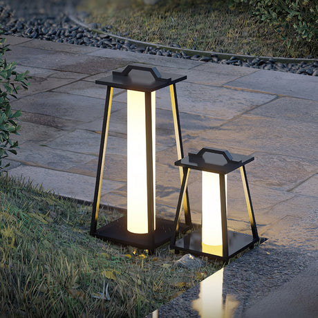 Two sizes lit on pale stone paving beside a mown lawn