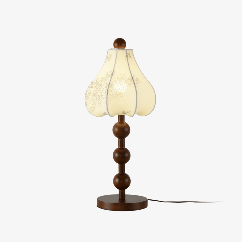 Floral table lamp with a petal shade on a stack of wood spheres, unlit