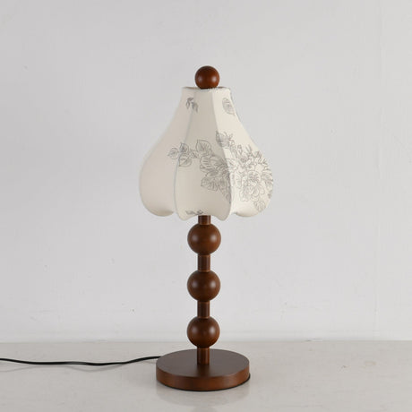 Walnut floral table lamp unlit, the printed pattern visible on the petals