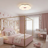Flower ceiling light above a pink canopy bed in a child bedroom