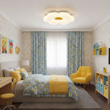 Flower ceiling light with a yellow center in a child bedroom with blue curtains