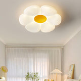 Flower ceiling light with a yellow center above a bedroom window